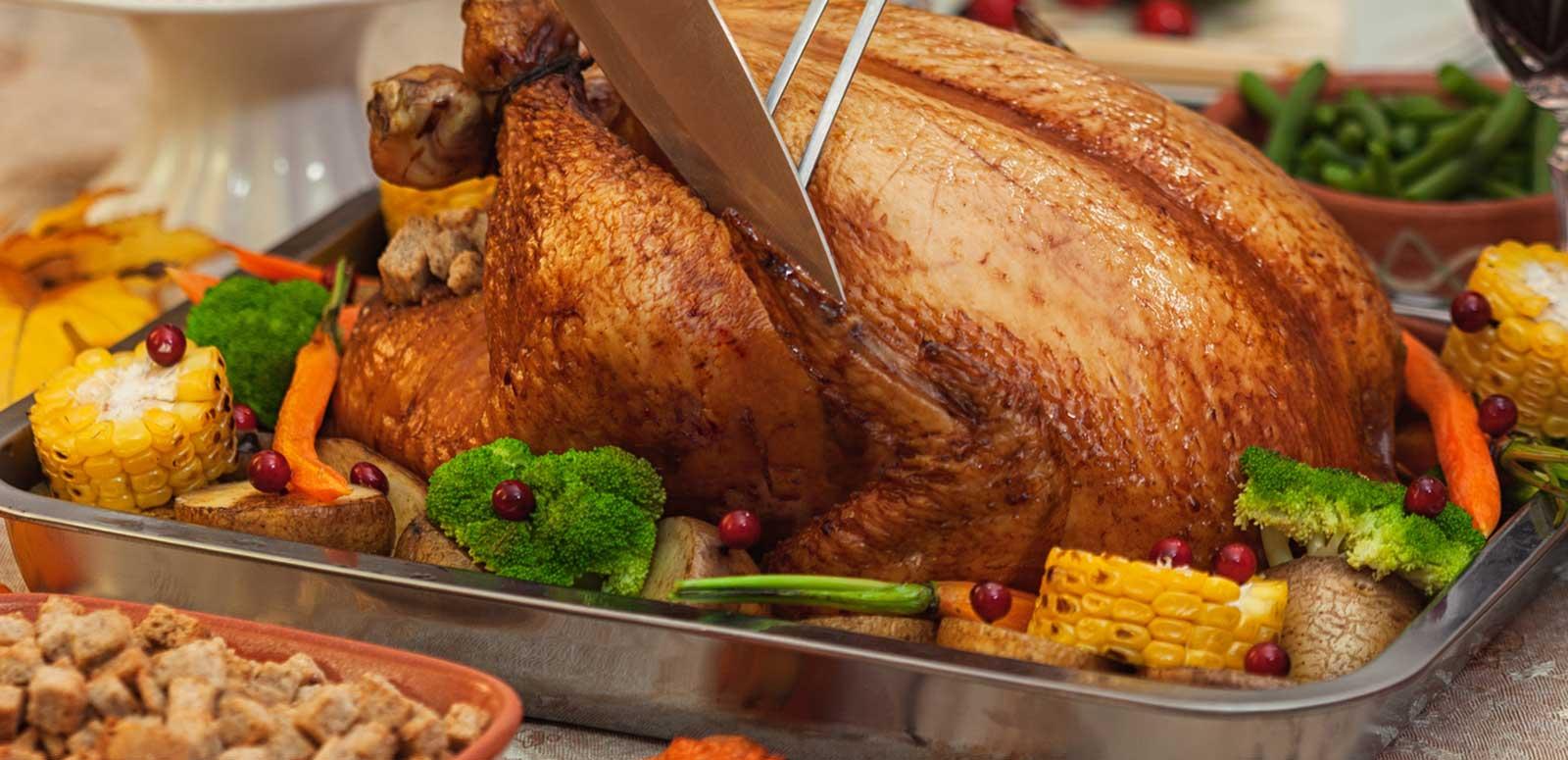 A roast chicken and vegetables on a platter. 