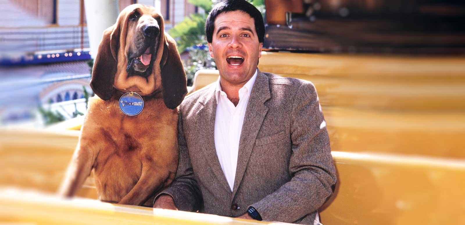 Simon Townsend sitting on a bench with his dog Woodrow