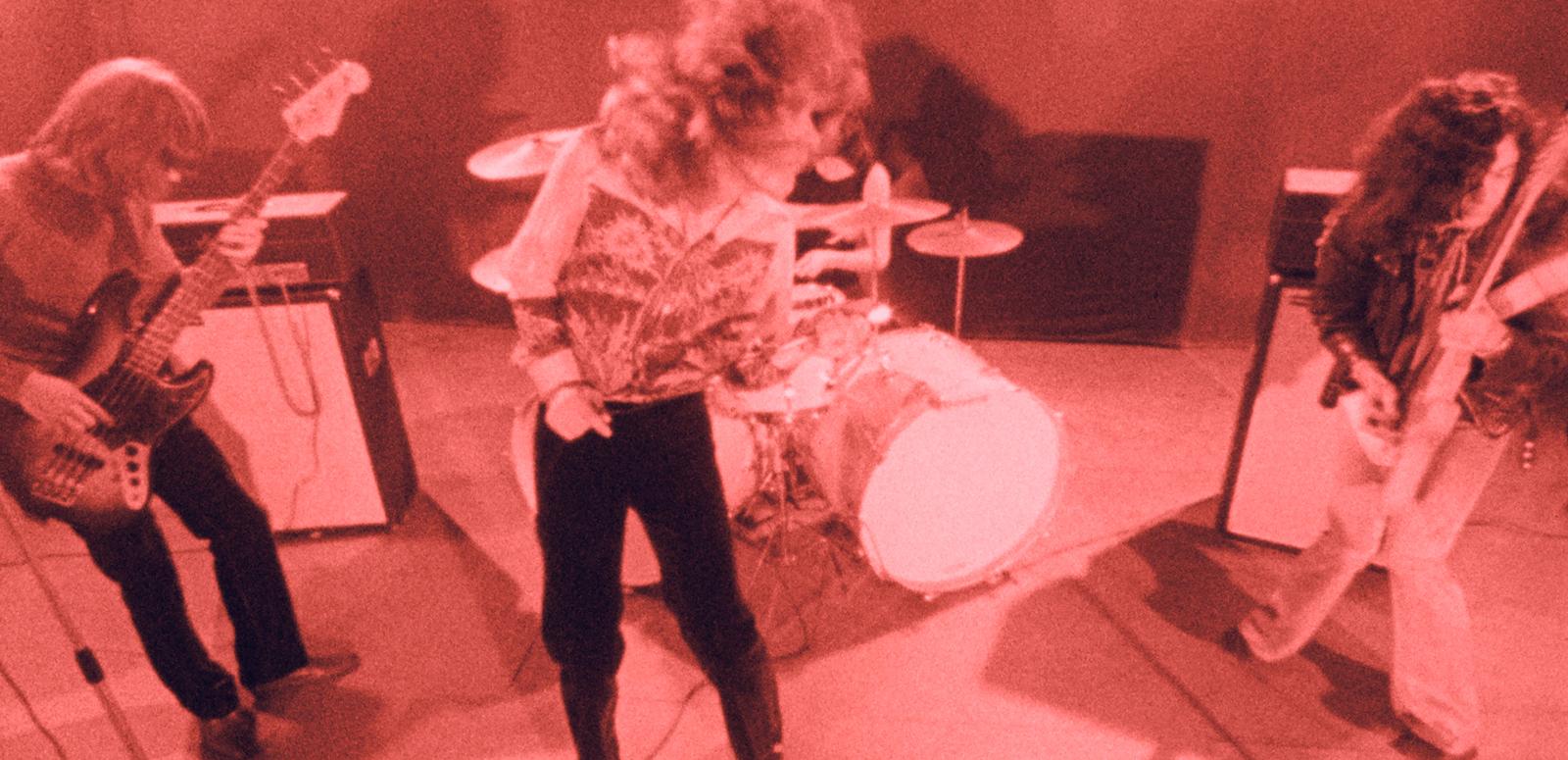 Rock band Led Zeppelin performing on stage in April 1969 under red lighting