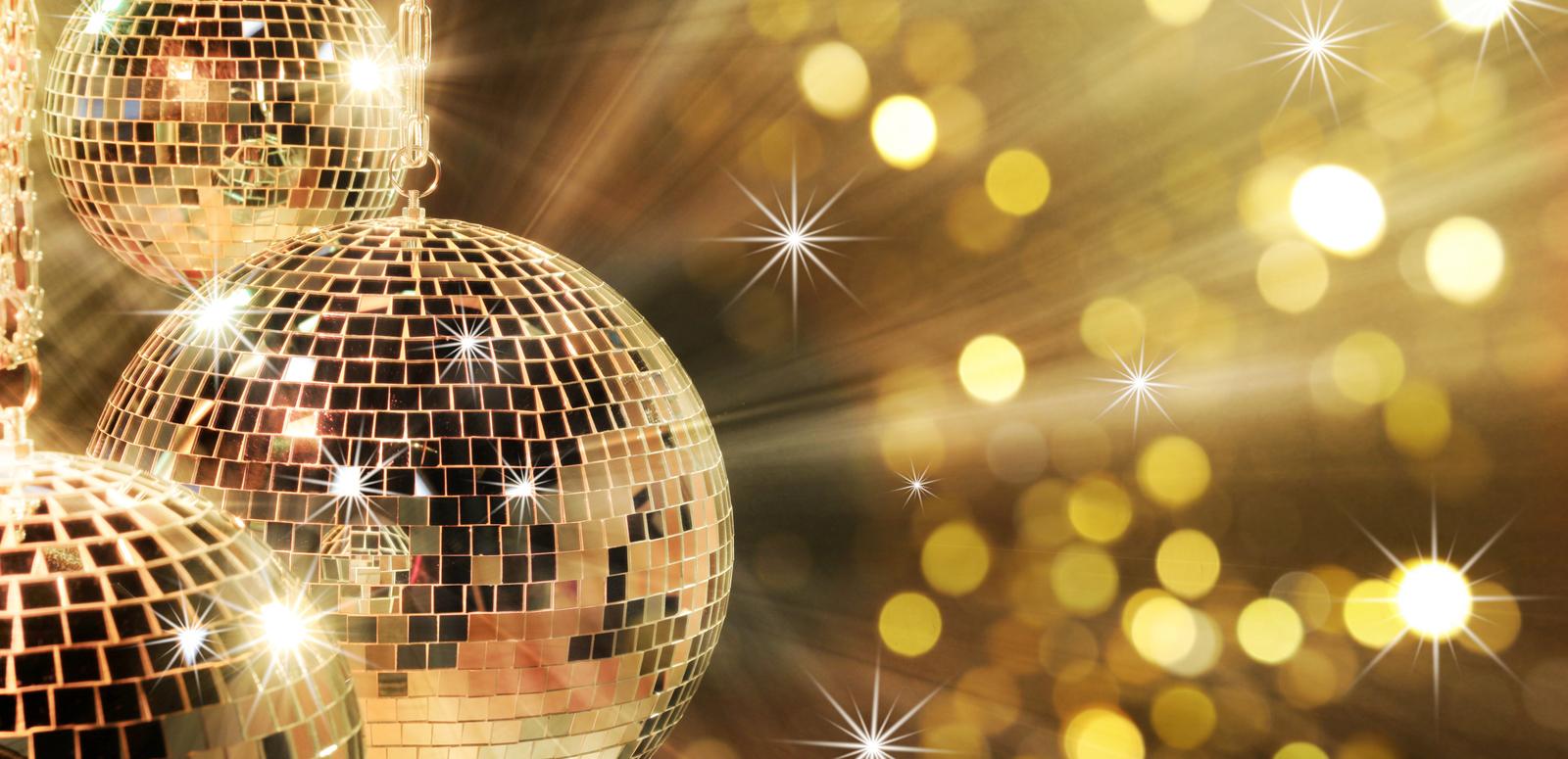 Three glittering disco balls reflecting sparkling golden light