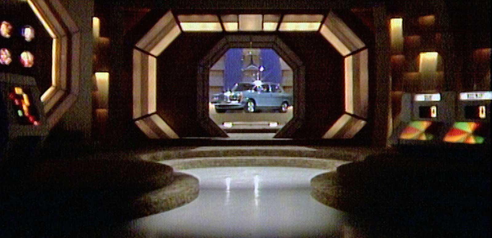 Shot of the interior of the studio of Sale of the Century. A blue car is being revealed through a lit up window.