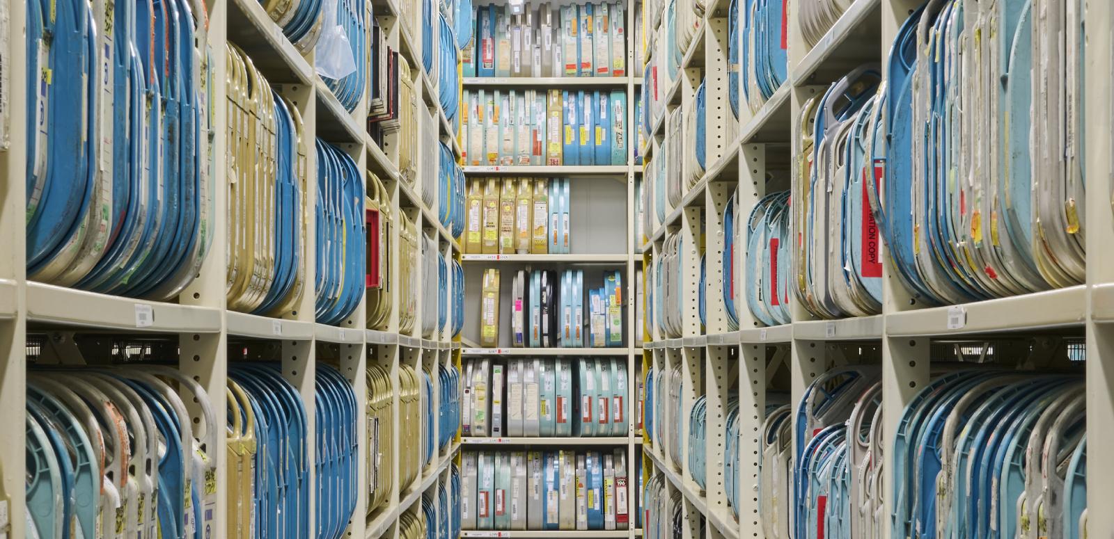 An aisle lined with shelves full of film containers