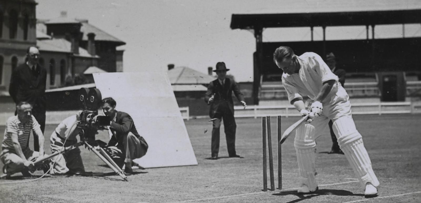 Donald Bradman batting in front of wickets while a film crew films him from behind Donald Bradman batting in front of wickets while a film crew films him from behind