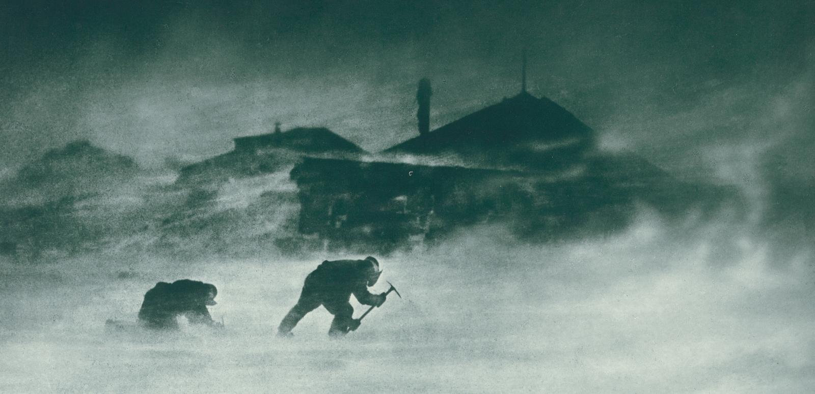 Two men leaning into a blizzard