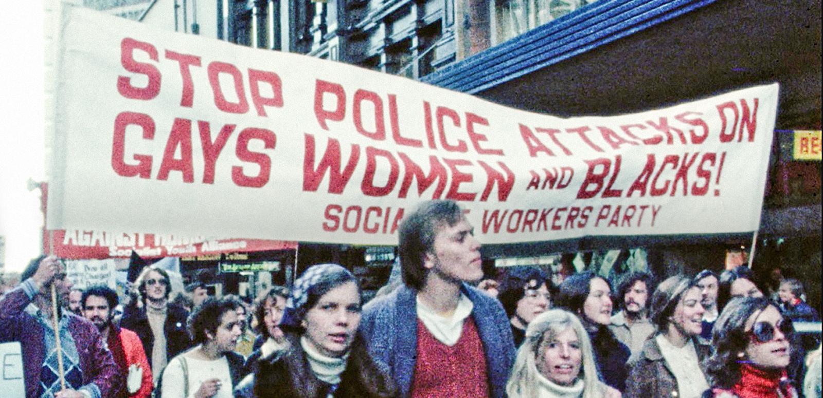 A Sydney protest march in the late 1970s with young people walking under a banner that reads 'Stop police attacks on gays, women and blacks!' A Sydney protest march in the late 1970s with young people walking under a banner that reads 'Stop police attacks on gays, women and blacks!'