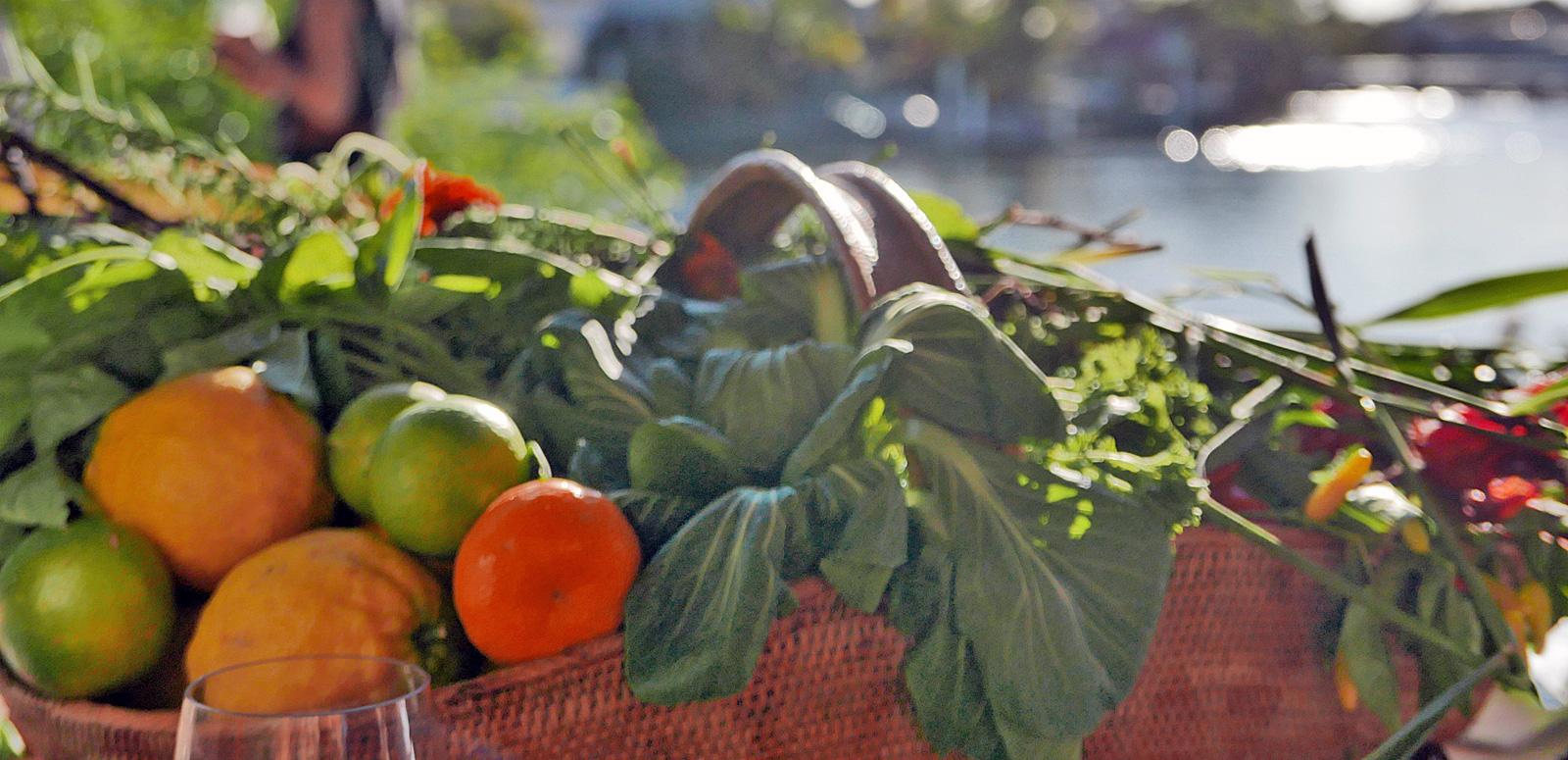 A close up of a basket containing fresh fruits and vegetables
