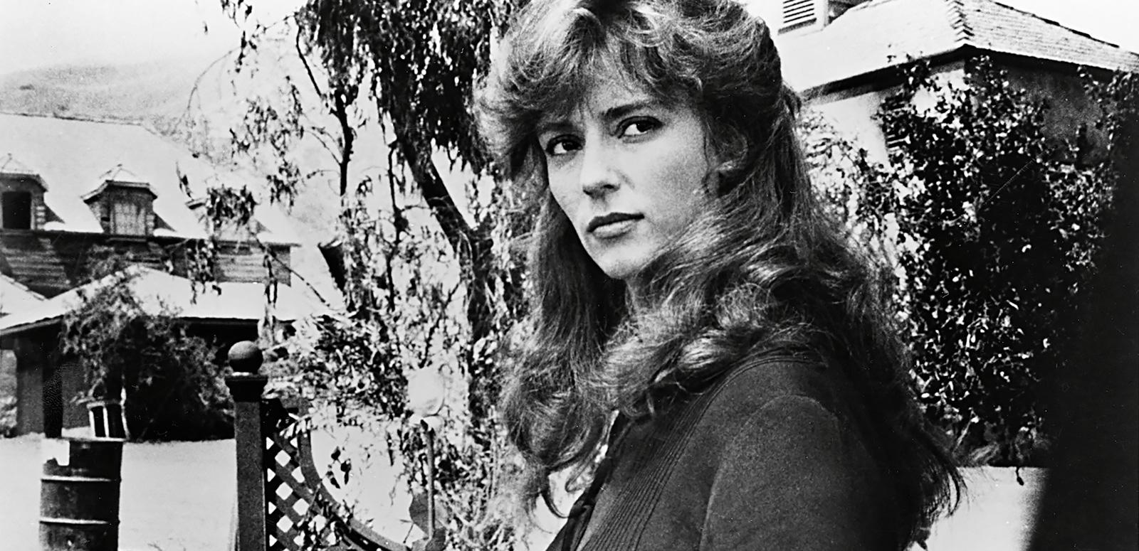 Rachel Ward holds a rose and turns her head to look at the camera in a scene from The Thorn Birds Rachel Ward holds a rose and turns her head to look at the camera in a scene from The Thorn Birds