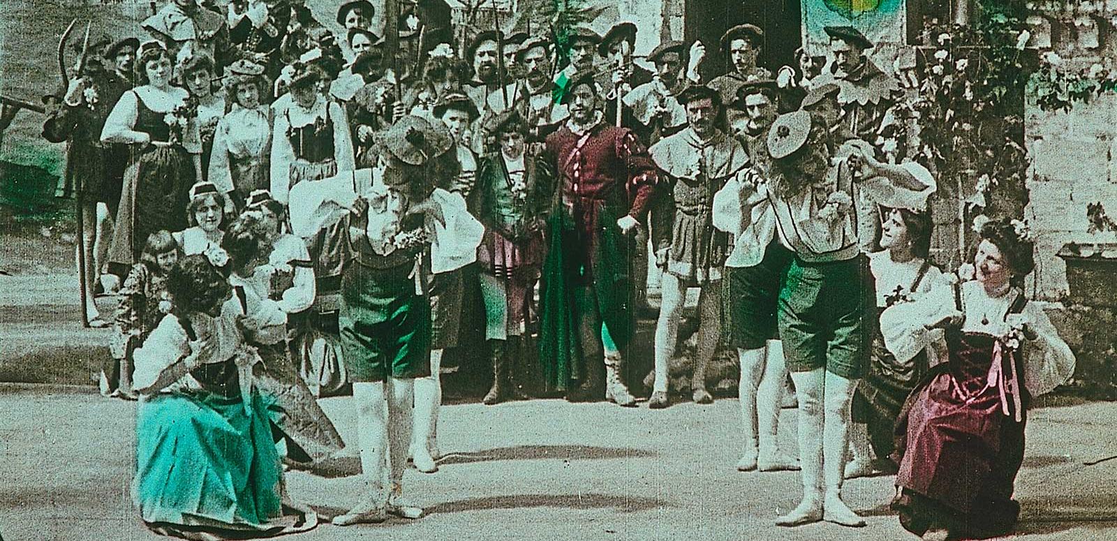 screenshot from an early tinted film showing a group of dancers