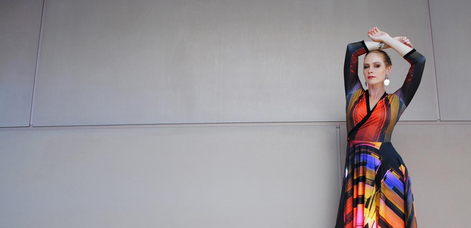Model posing against a wall, wearing Yumi Morrissey's NFSA building dress