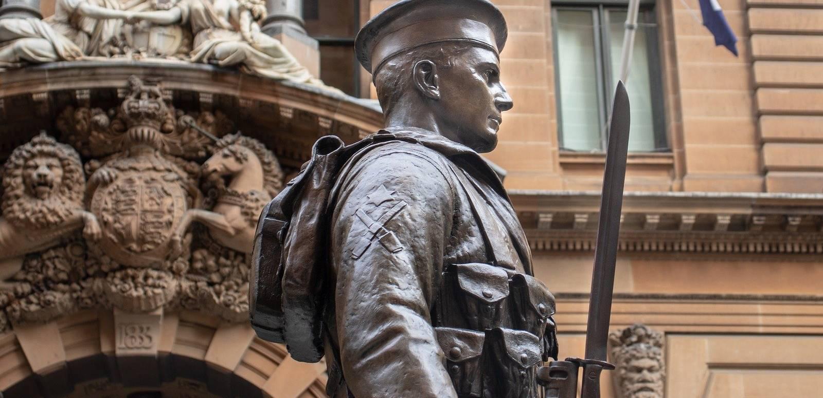Detail of a statue of a soldier in uniform, part of an Anzac memorial