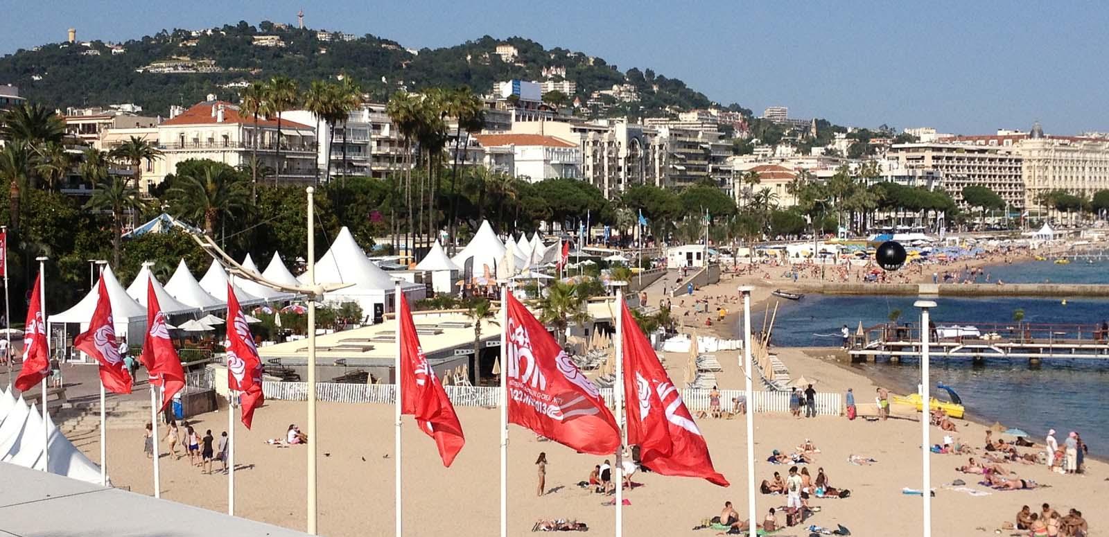 The beach front at Cannes with red flags in the foreground The beach front at Cannes with red flags in the foreground