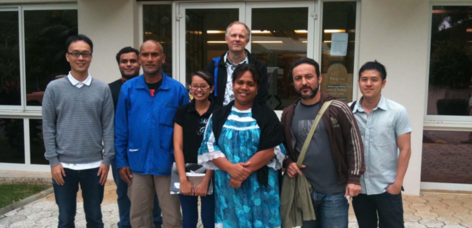 A group of conference delegates standing outside the New Caledonia national archives.