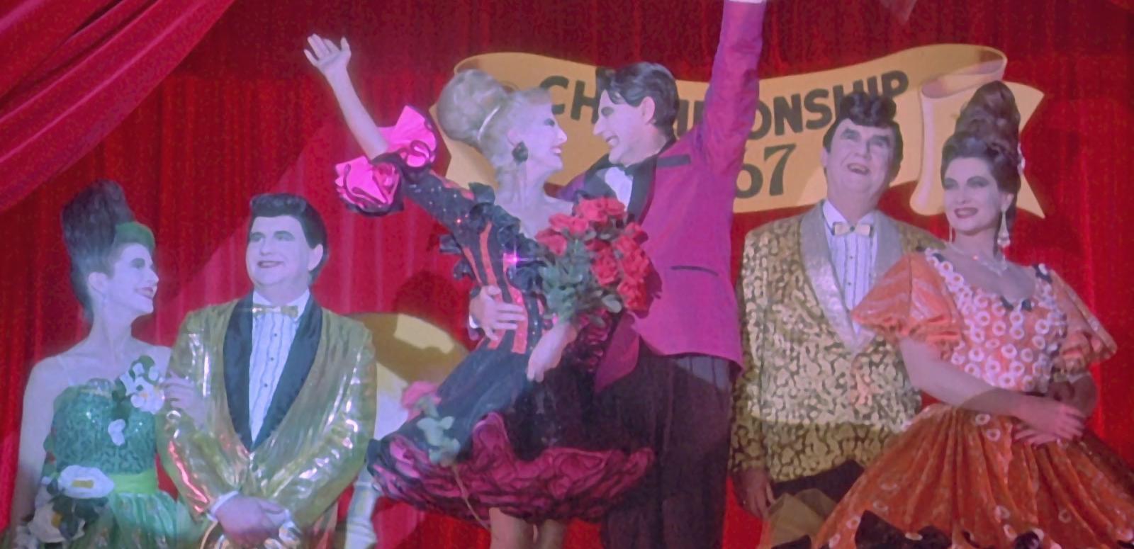 Strictly Ballroom flashback scene three couples dressed overly garishly in ballroom dancing costumes