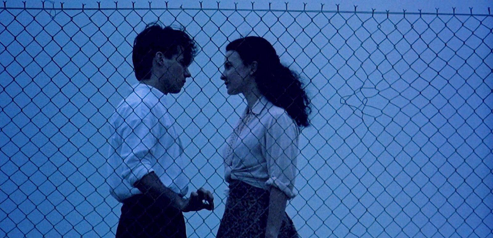 Paul Mercurio and Tara Morice in scene from the film Strictly Ballroom. Paul Mercurio and Tara Morice in scene from the film Strictly Ballroom. They are facing each other in front of a wire fence. The time of day seems to be early evening.