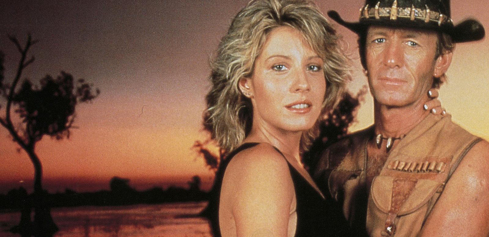 Paul Hogan as Mick Dundee and Linda Kozlowski as Sue Charlton in a cocktail party scene from Crocodile Dundee
