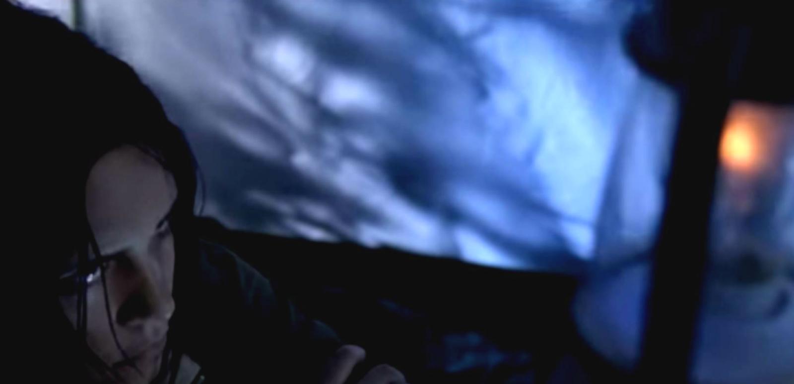 Matt Bird hero image Screen grab from short film Min Min, directed by Matt Bird. Shows scared young woman waiting in a tent with a dim lantern.