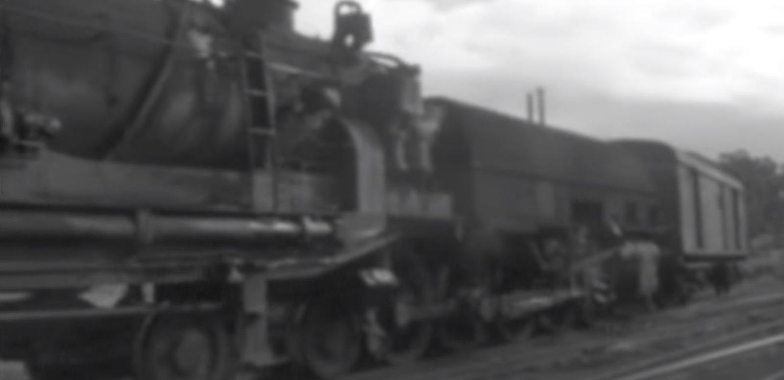 Screenshot of amateur black and white footage showing train passing in Newcastle, circa 1970s. 