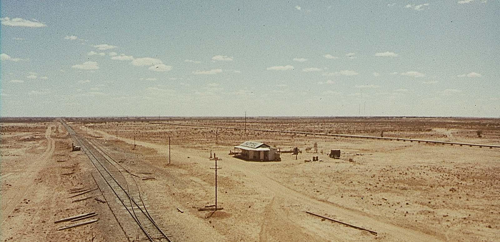 An aerial shot of a hotel and railway line in a vast expanse of outback, in a scene from the 1971 film Wake in Fright An aerial shot of a hotel and railway line in a vast expanse of outback, in a scene from the 1971 film Wake in Fright