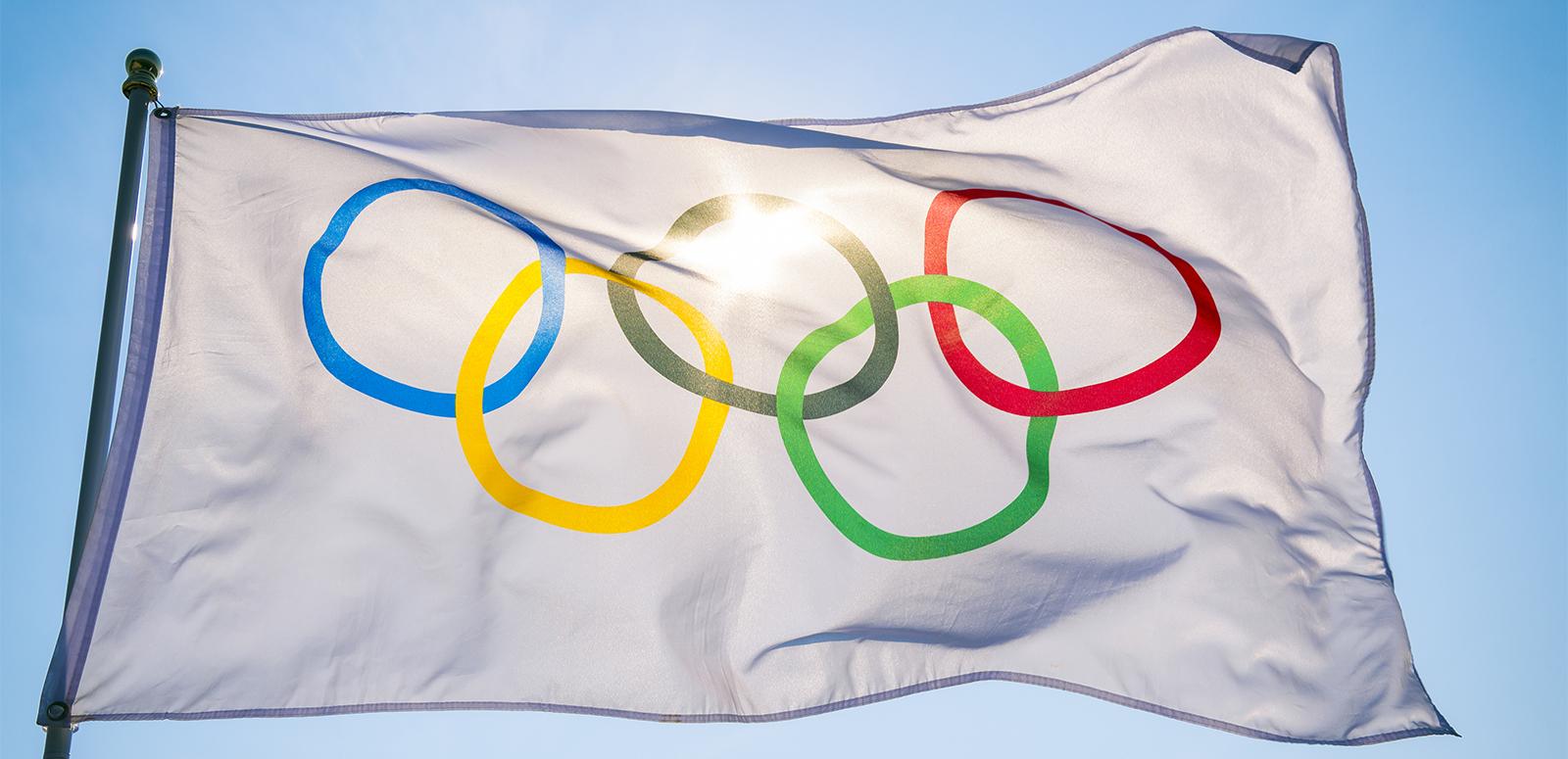 The Olympic flag against a blue sky The Olympic flag against a blue sky
