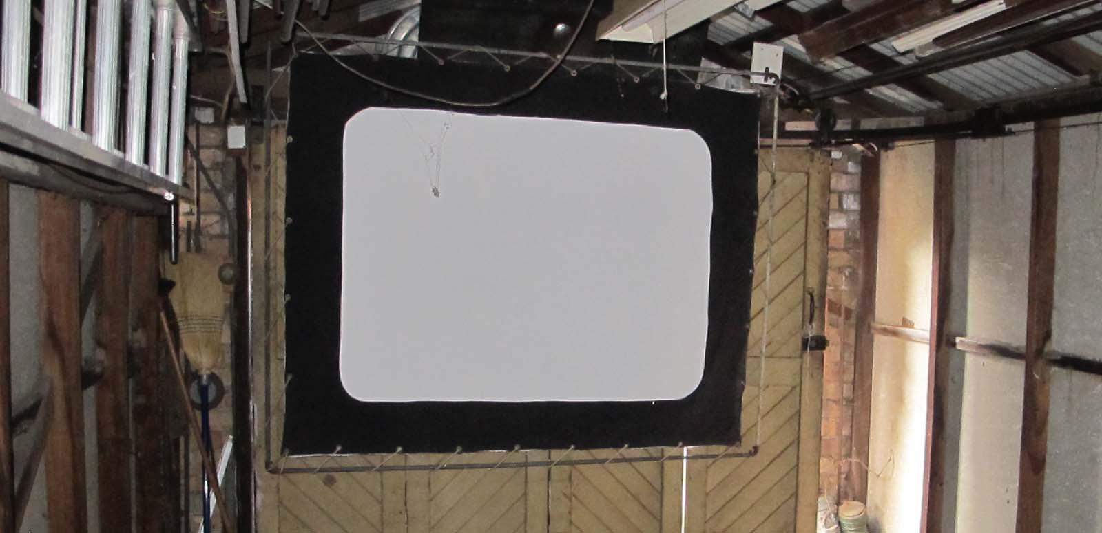 A screen hanging in a garage in Wollongong, part of the 1940s home cinema set-up of film projectionist Eddie Vormister A screen hanging in a garage in Wollongong, part of the 1940s home cinema set-up of film projectionist Eddie Vormister