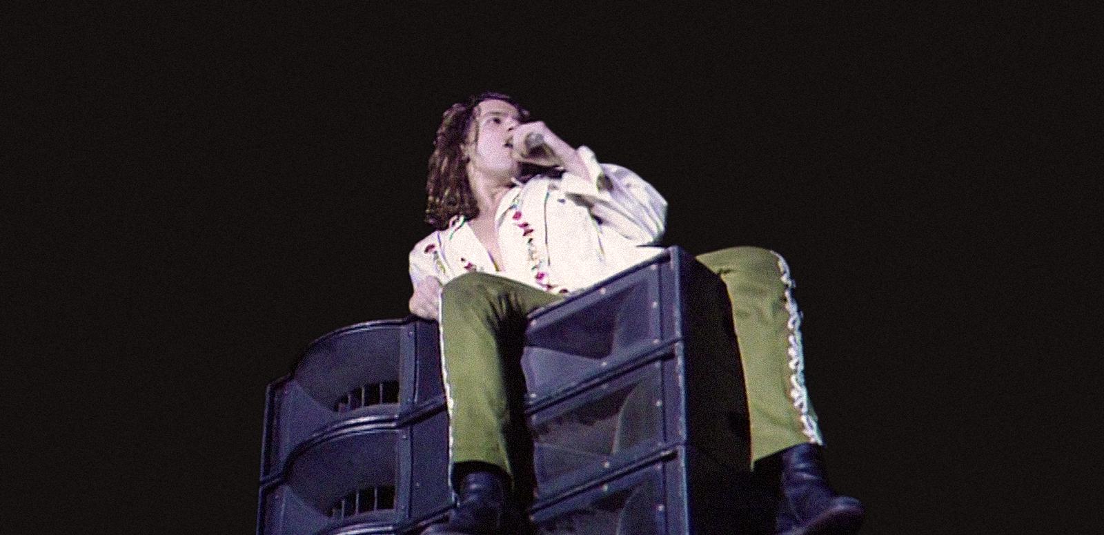 Michael Hutchence of INXS in concert, singing while seated on a loudspeaker Michael Hutchence of INXS in concert, singing while seated on a loudspeaker