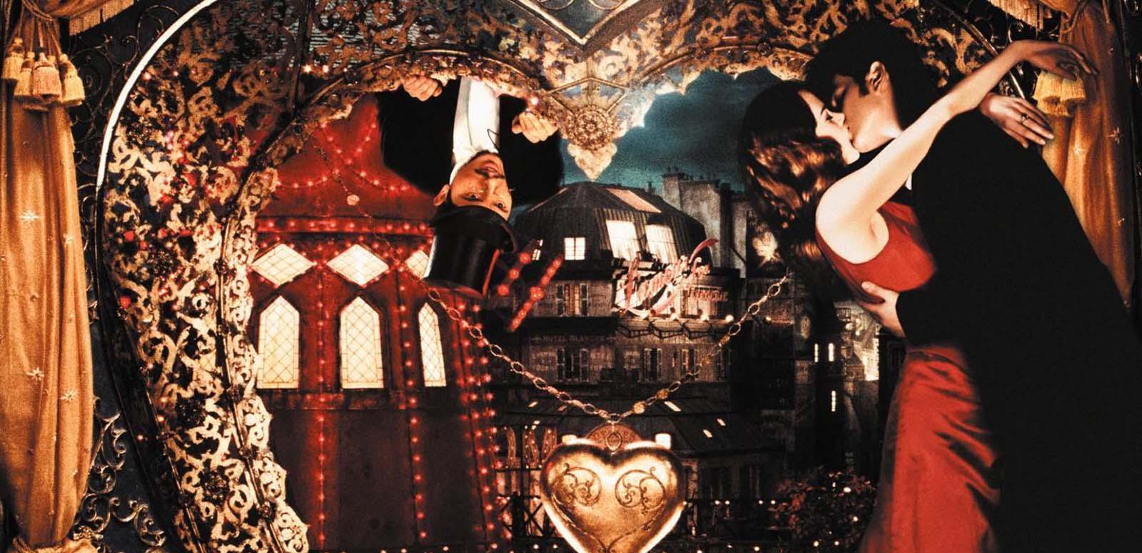 Satine and Christian embrace in her chambers while Toulouse-Lautrec peers down at them from outside a heart-shaped window, in a scene from Moulin Rouge! Satine and Christian embrace in her chambers while Toulouse-Lautrec peers down at them from outside a heart-shaped window, in a scene from Moulin Rouge!