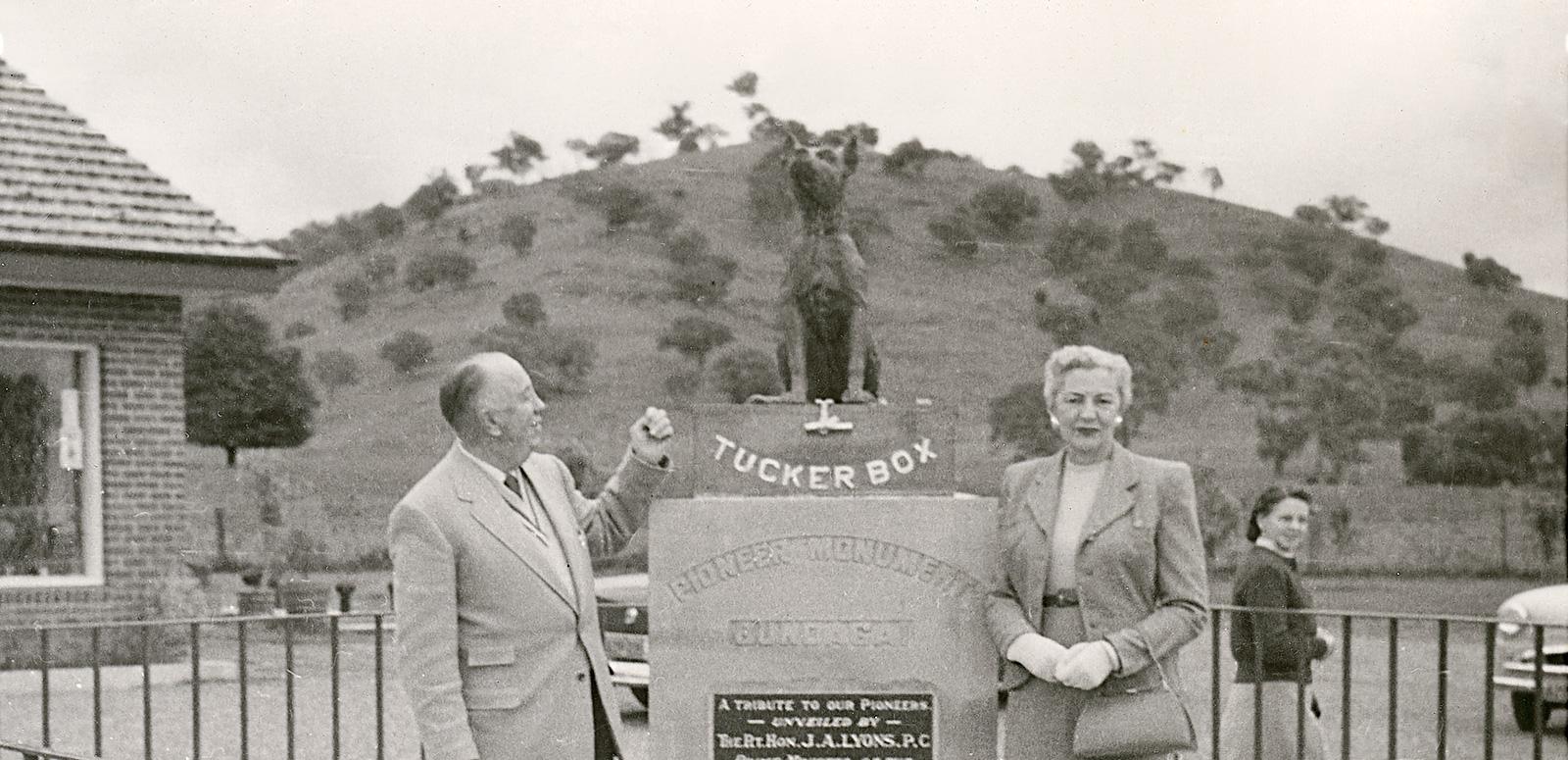 Jack O'Hagan standing beside a statue of the dog on the tuckerbox in Gundagai.