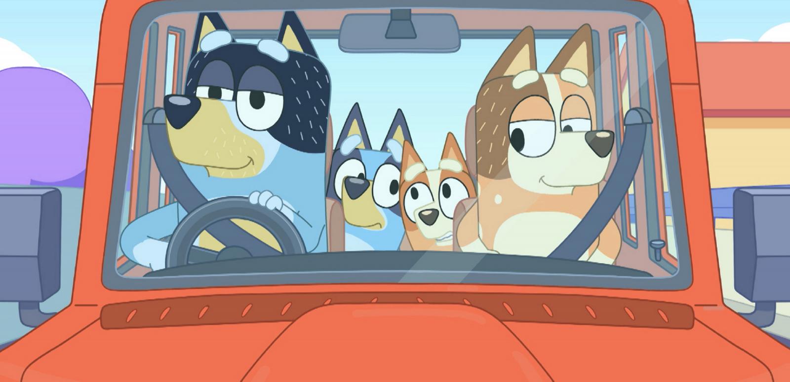 Cartoon of dog parents in a car with their dog children in the back.