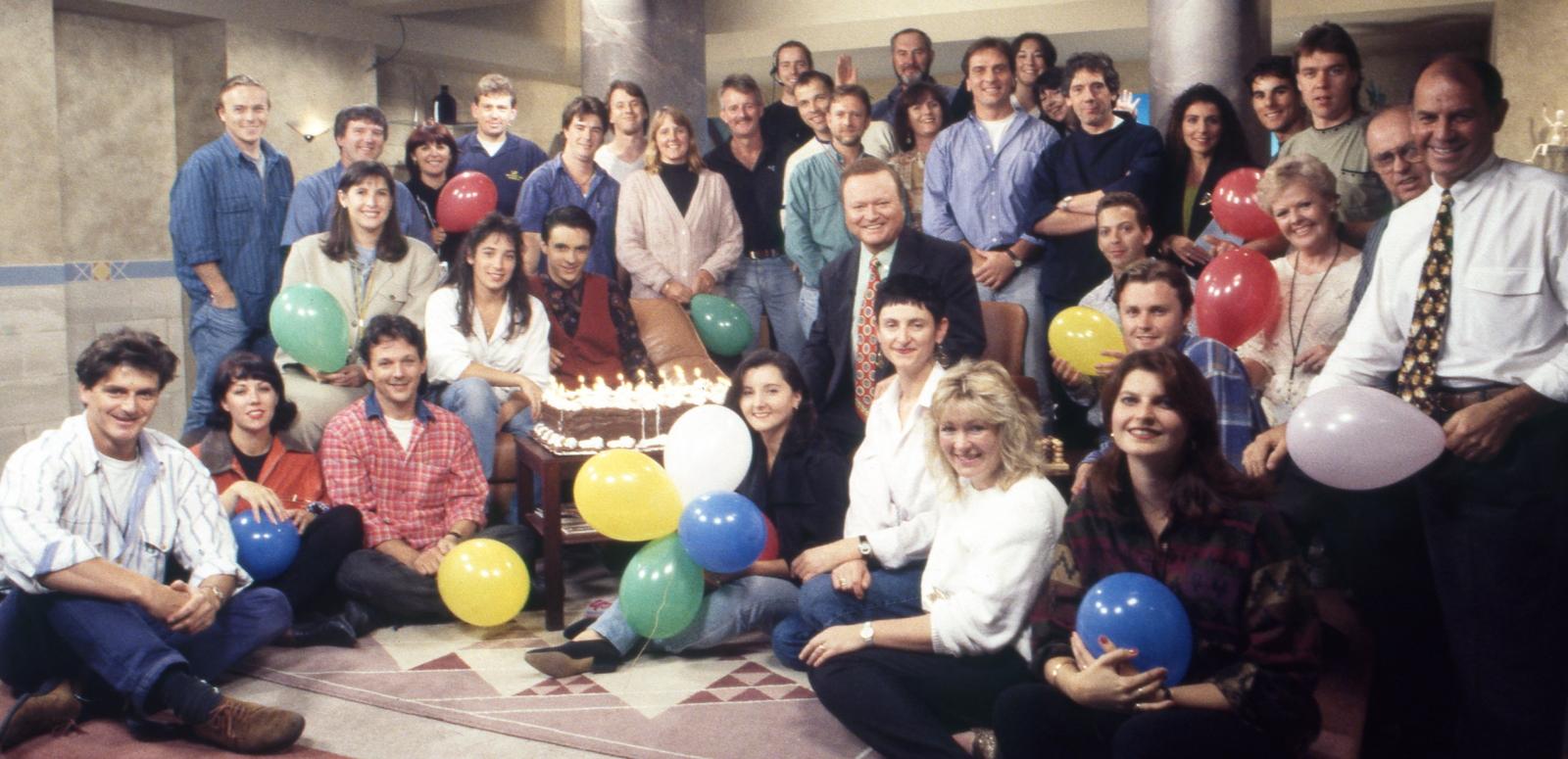 Bert Newton surrounded by his TV crew