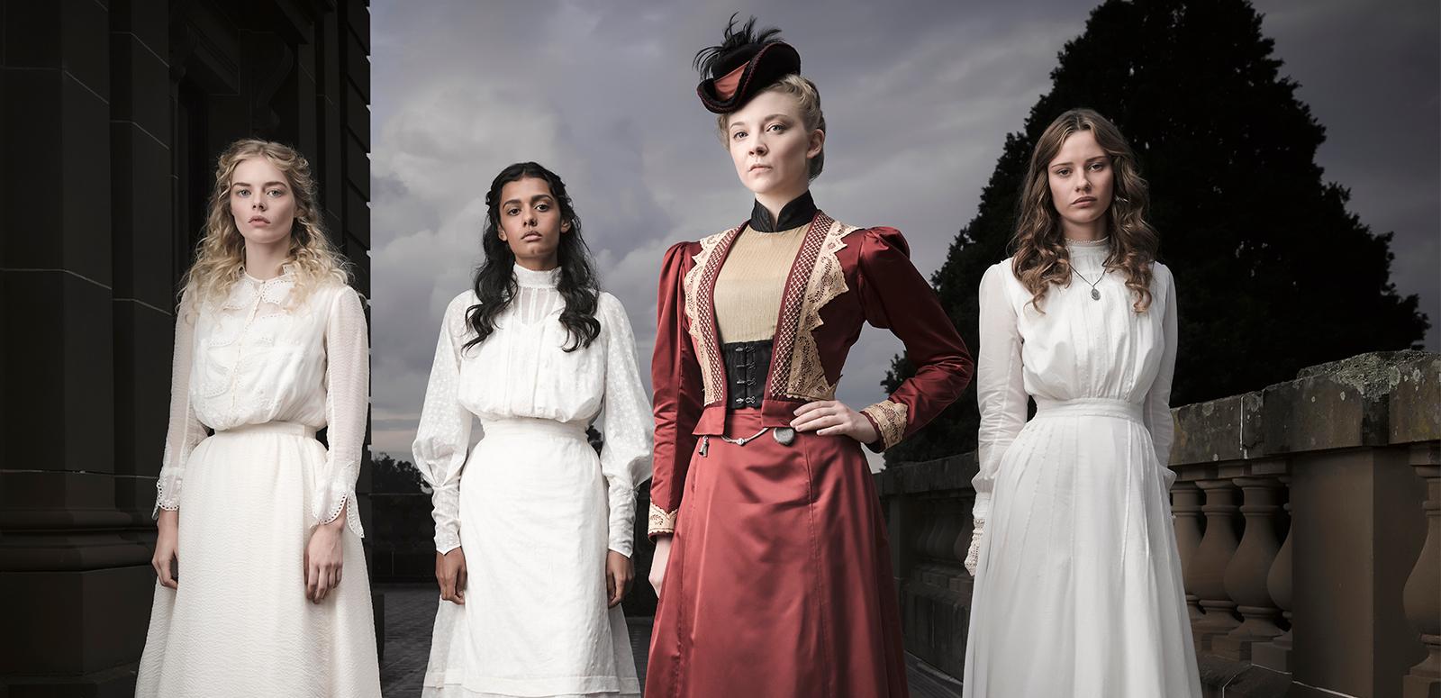 Four womern standing in a line in period costume