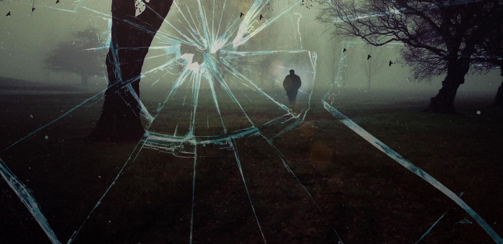 Australian True Crime Mysteries hero image View from a window that has been shattered showing a dark, shadowy figure of a man walking through a grassy field between some trees.