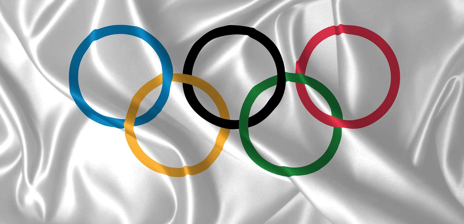 The Olympic rings on a silver satin cloth