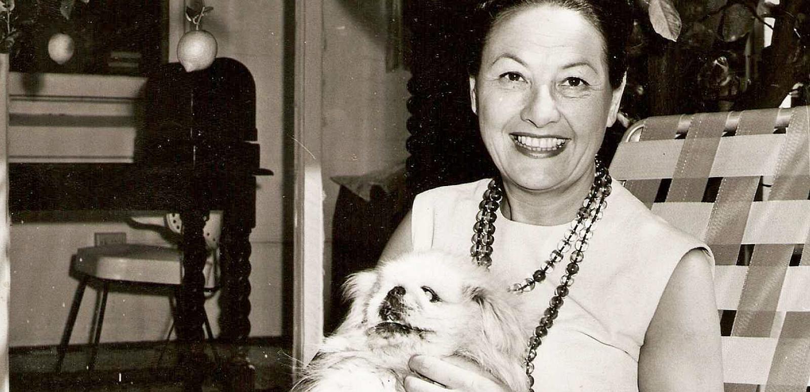 Biny Lum hero image Binny Lum holding her dog, Ming. Circa 1960s.