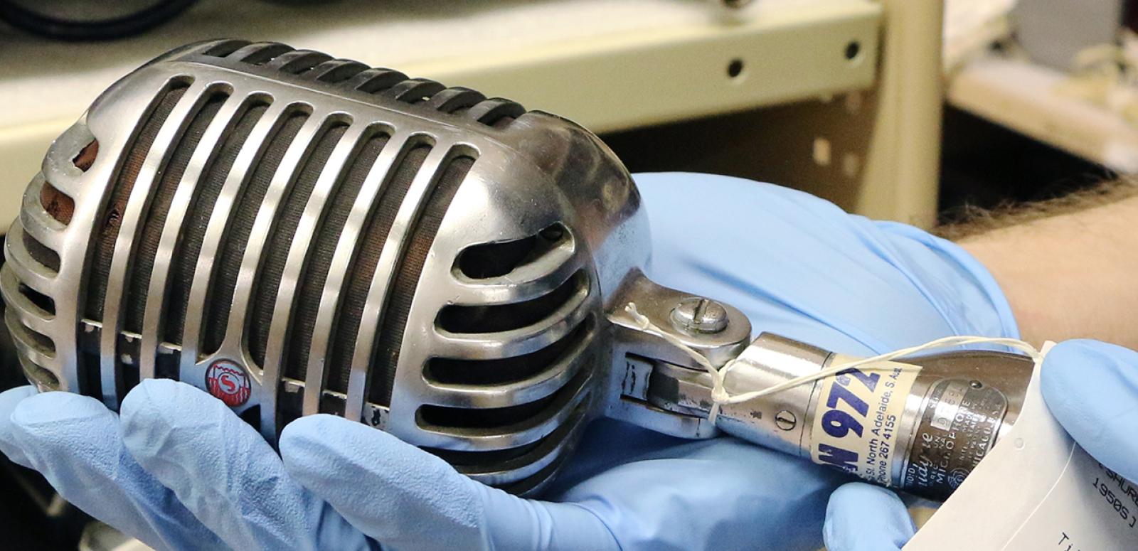 Oral history - Musicians A NFSA curator holds a vintage microphone