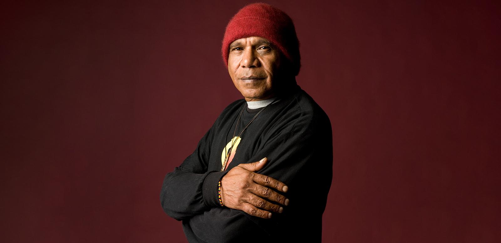 Archie Roach curated collection Archie Roach looks at the camera with his arms folded.