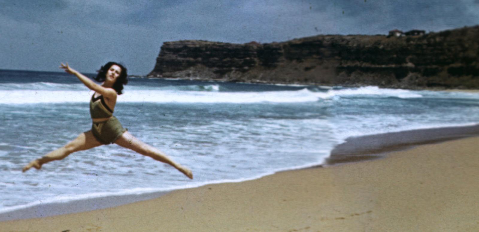 Ballet Russes hero image Tamara Toumanova from Ballet Russes performs a dance routine on the beach.