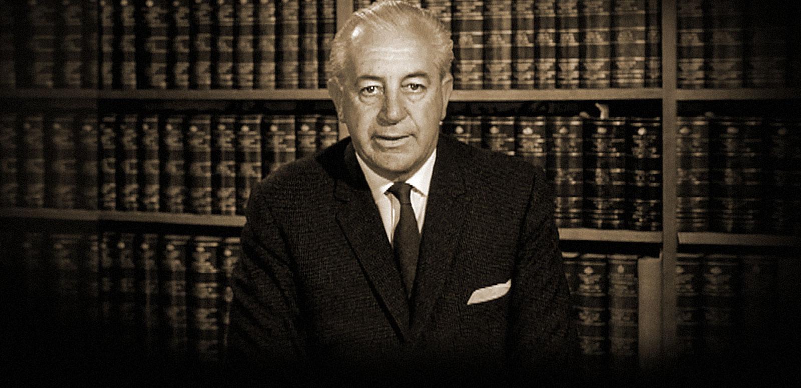 A sepia image of Harold Holt as federal treasurer, seated behind a desk and recording an address to the nation A sepia image of Harold Holt as federal treasurer, seated behind a desk and recording an address to the nation