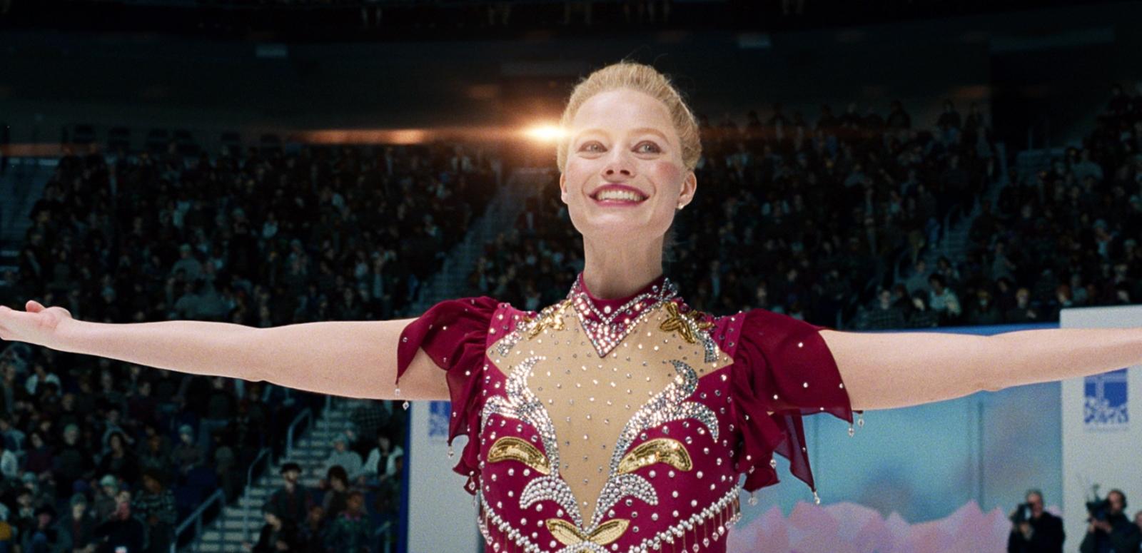 Figure skater smiling with her arms extended Figure skater smiling with her arms extended