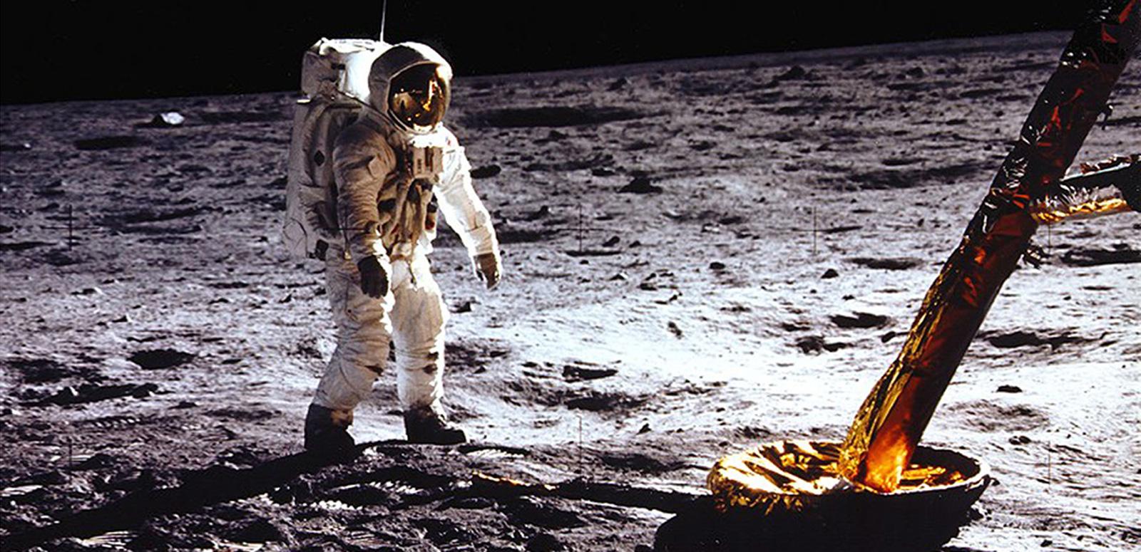 NASA astronaut on the moon next to the leg of the landing craft NASA astronaut on the moon next to the leg of the landing craft