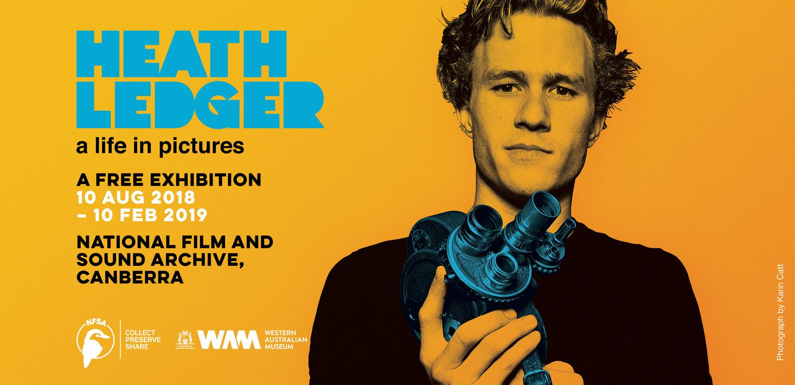 Heath Ledger holding a camera against a saturated orange background. Heath Ledger holding a camera against a saturated orange background.