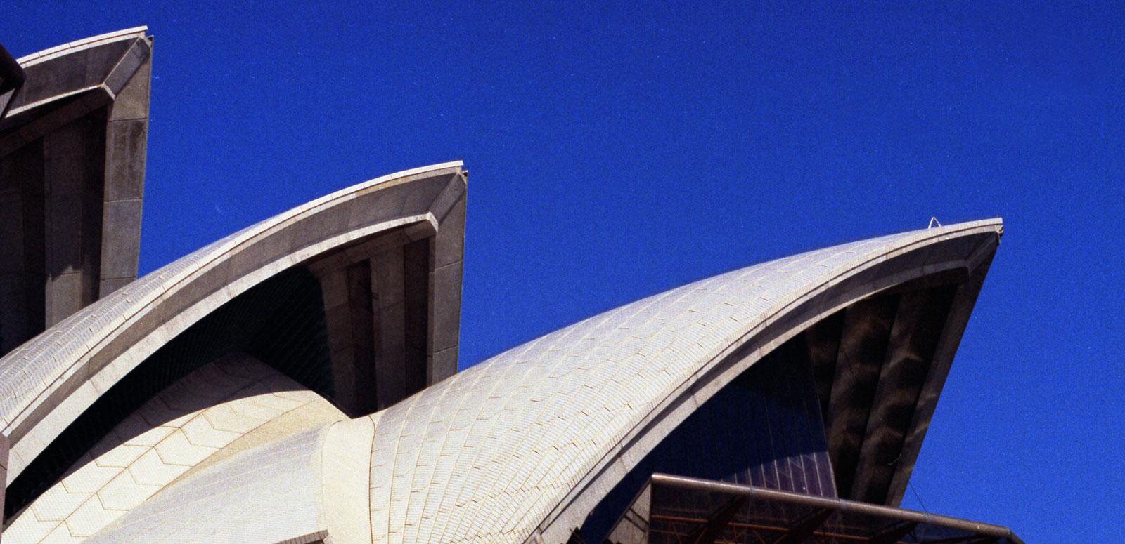 Three of the sails of the Sydney Opera House with bright blue sky in the background. Three of the sails of the Sydney Opera House with bright blue sky in the background.