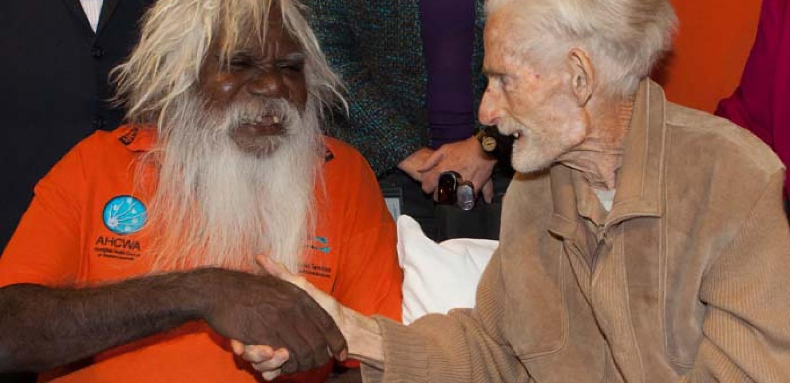 Bruce Thomas, Chair of the Wangka Maya’s Board of Directors (left), shakes hands with John Hutchinson (right)