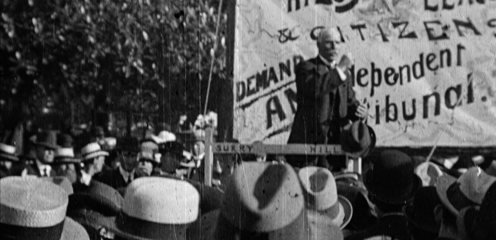 Frame capture from 'The Great Strike' A group of people wearing hats at a protest during the Great Strike of 1917
