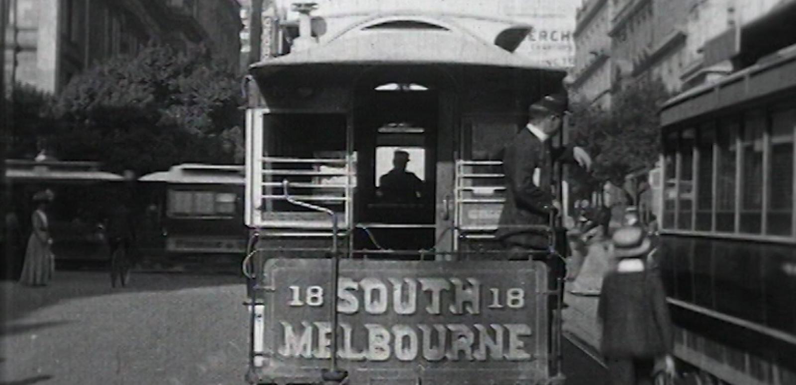 Black and white still of the back of a number 18 South Melbourne tram in the 1910s.