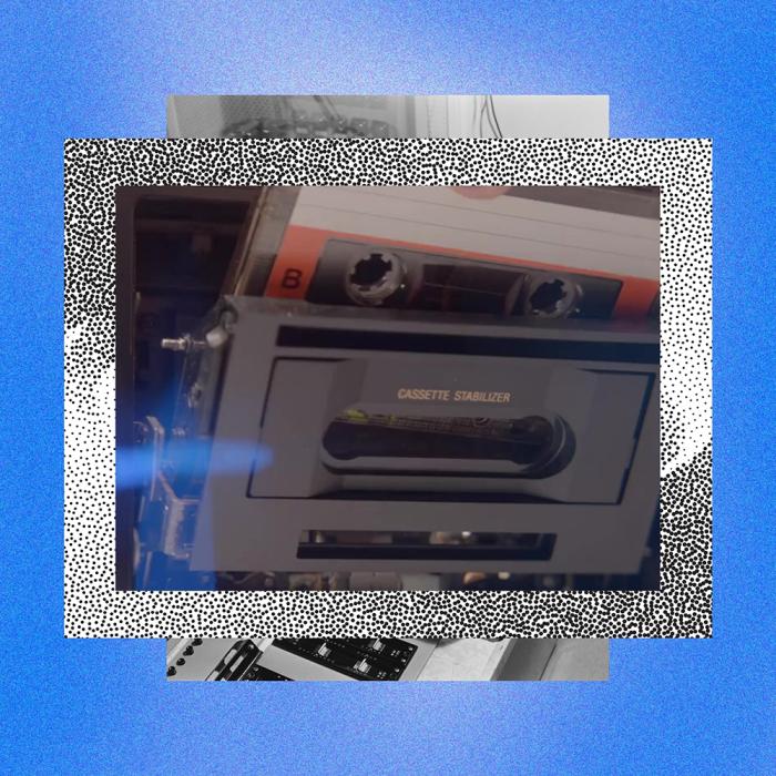 A cassette tape being inserted into a cassette player