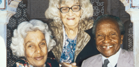 Three elderly people smiling at the camera