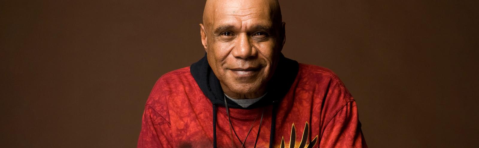 Head and shoulders shot of musician Archie Roach smiling at camera.