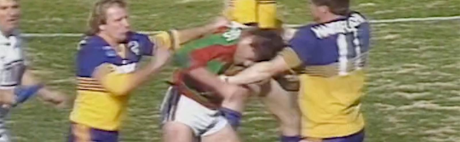 3 men on a football field playing a game of Rugby League