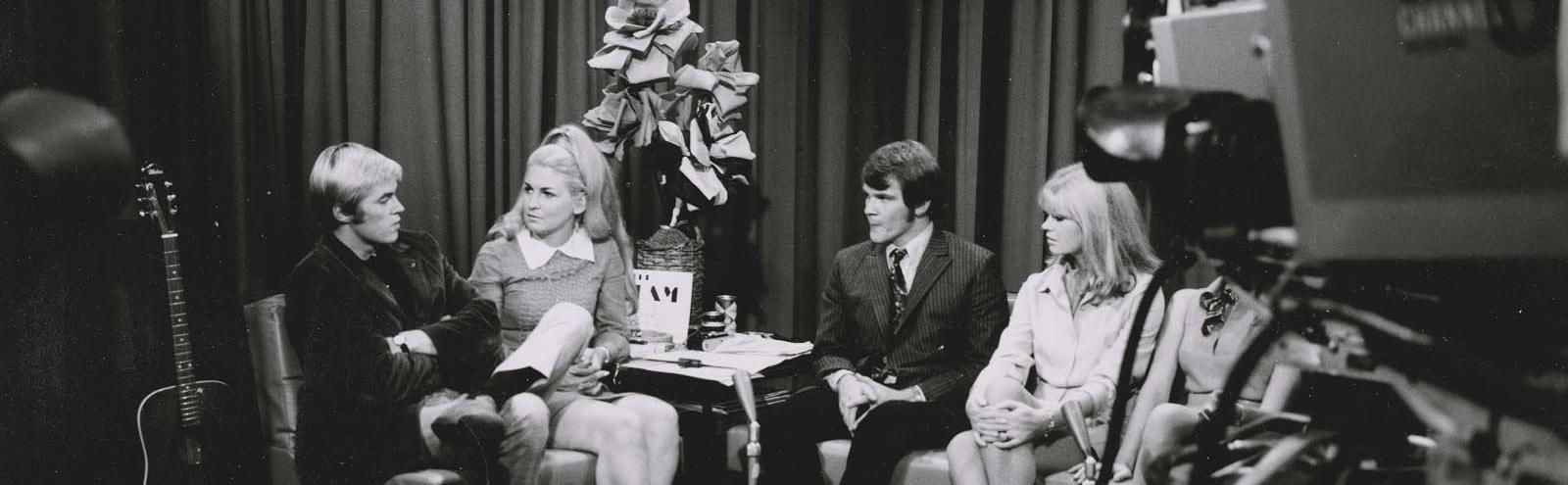 Carol West, Ross D Wyllie and an unidentified man and woman engaged in a production discussuion on the set of music television show Uptight in 1968.