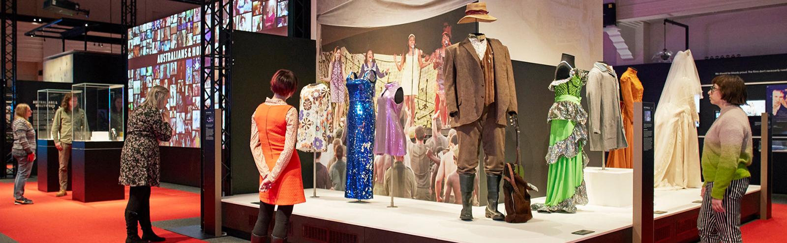 People looking at items in an exhibition space.